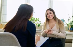 Psychologue souriante en consultation avec une patiente