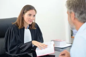 Avocate en robe recevant un client dans son bureau